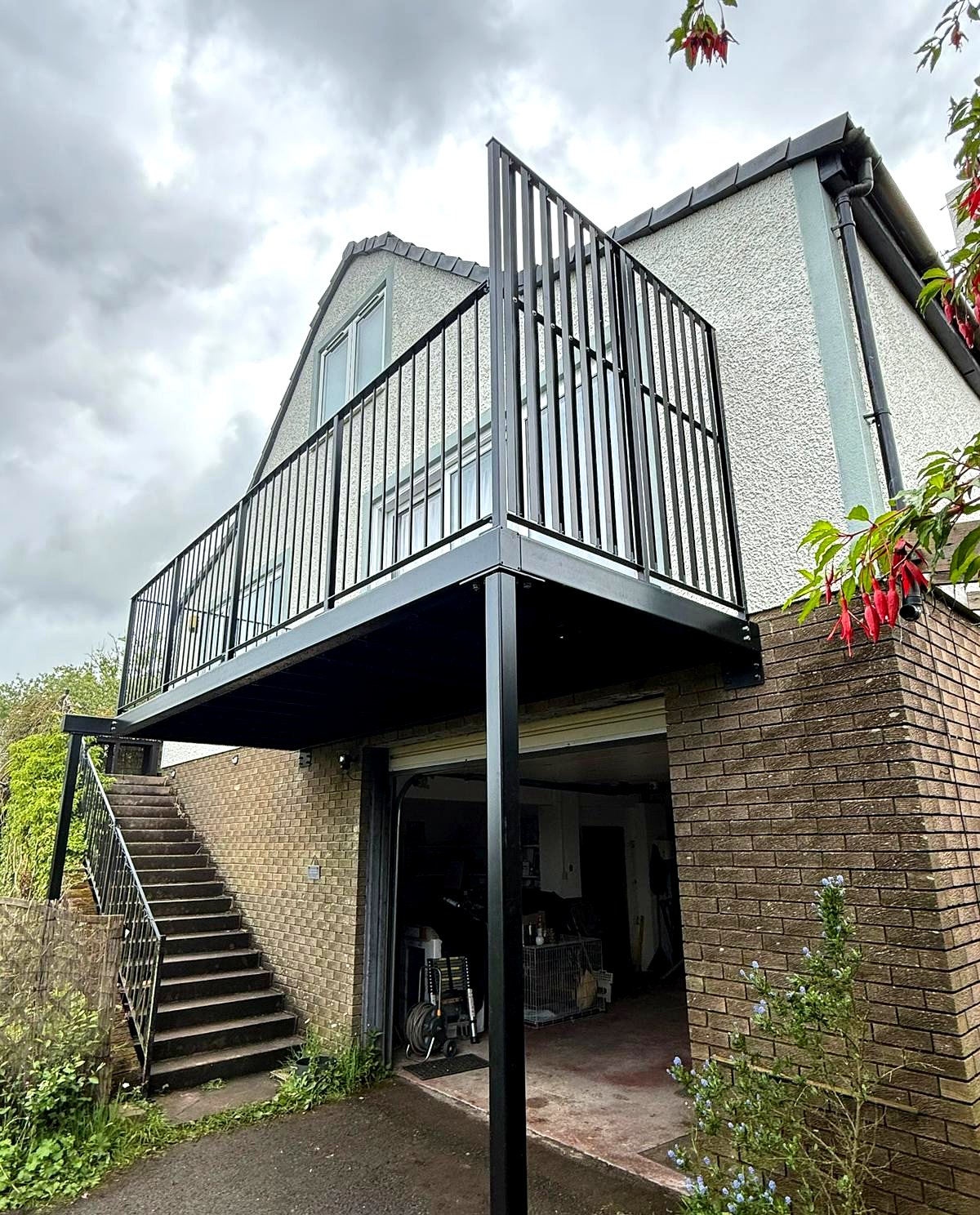 Galvanised and powder-coated black steel walkout balcony over a garage, Crummock, Cumbria
